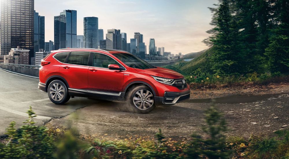 A red 2021 Honda CR-V is shown from the side after looking for cars for sale in Jersey City.